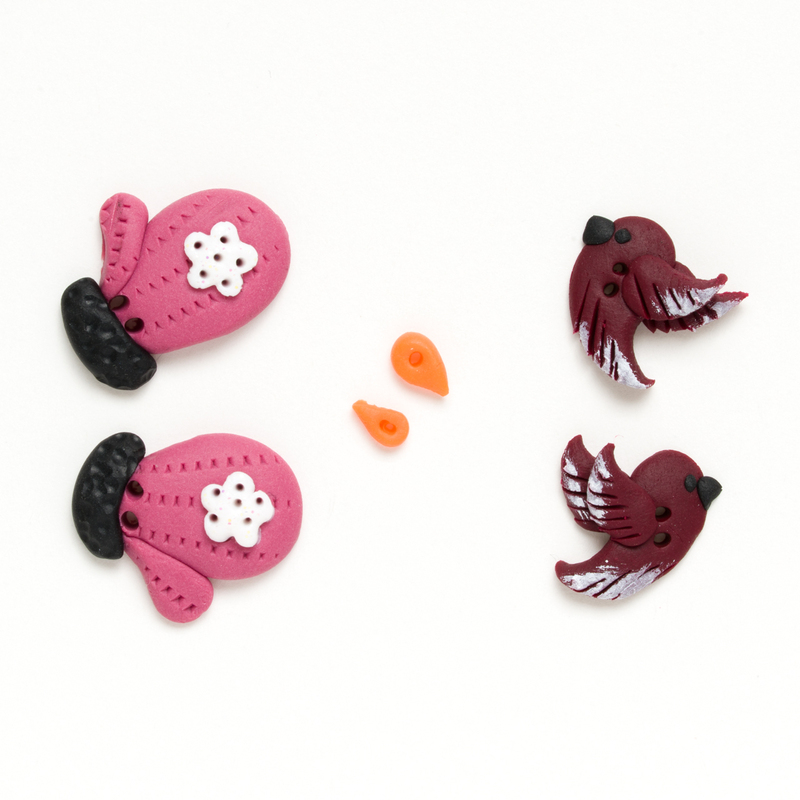 Clay button pack of red birds, pink mittens, and orange carrot noses, isolated on a white background. 