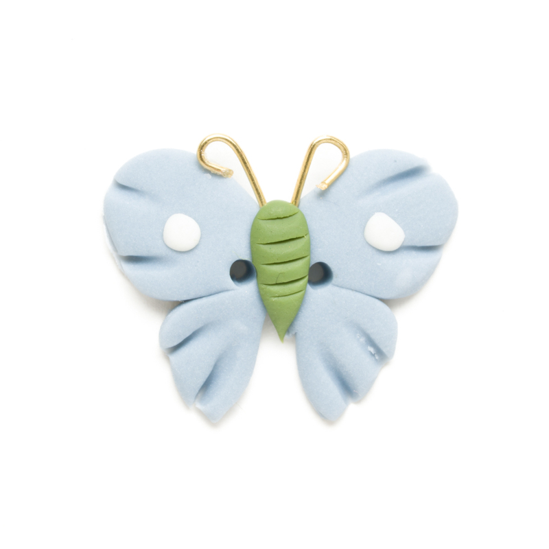 Light blue and green butterfly clay button, isolated on a white background. 