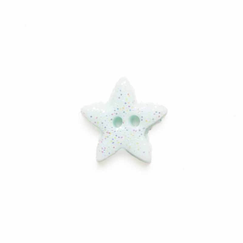 Medium light blue clay star button with glitter, isolated on a white background. 