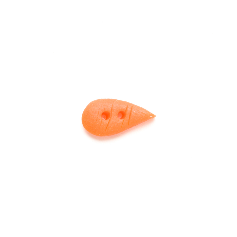 Orange carrot-shaped clay button on a white background.