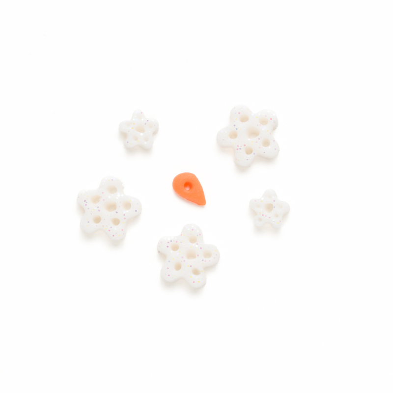 Clay button pack with winter themed charms, isolated on a white background. 