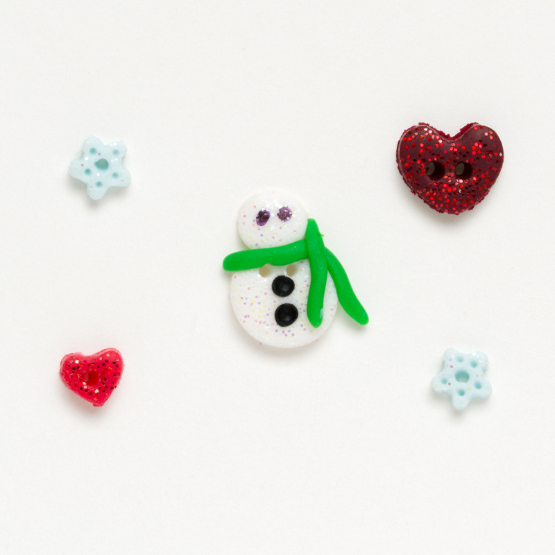 Clay button pack of winter themed charms, isolated on a white background. 