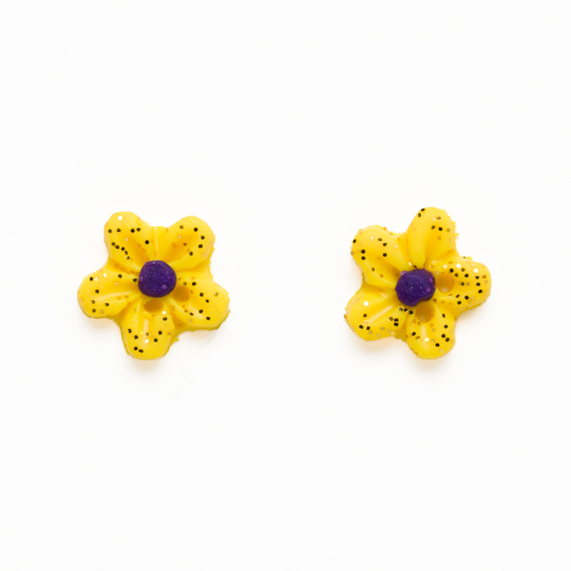 Two small yellow glittery clay flower buttons, isolated on a white background. 