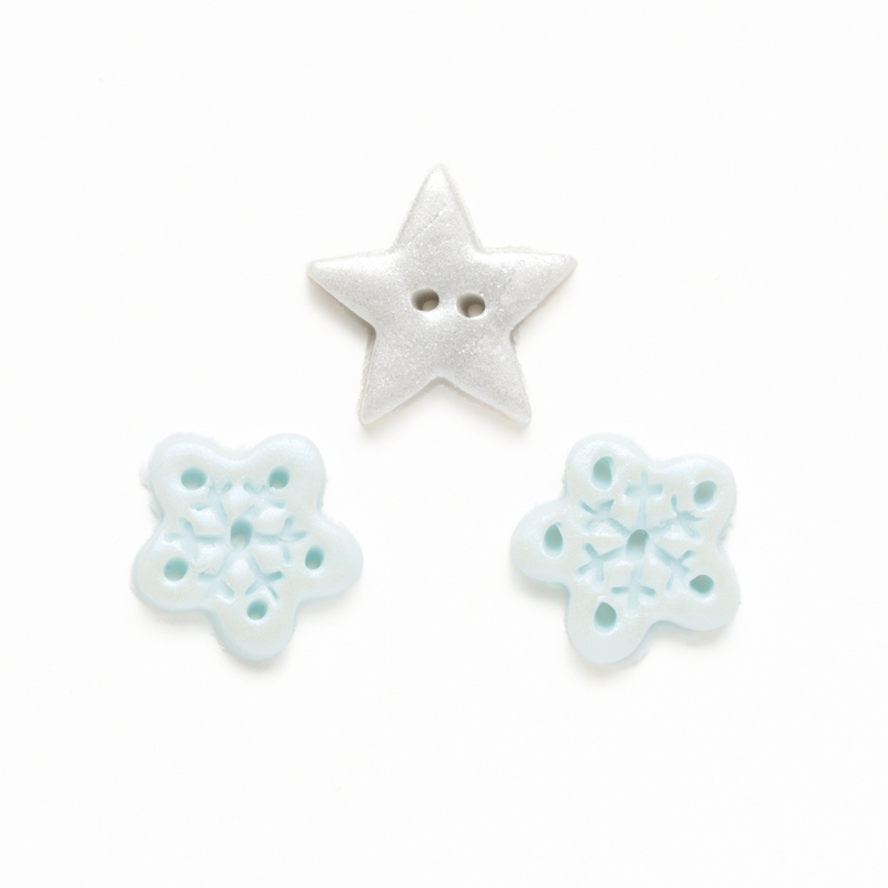 Clay button set of two glitter snowflakes and a silver star, isolated on a white background. 