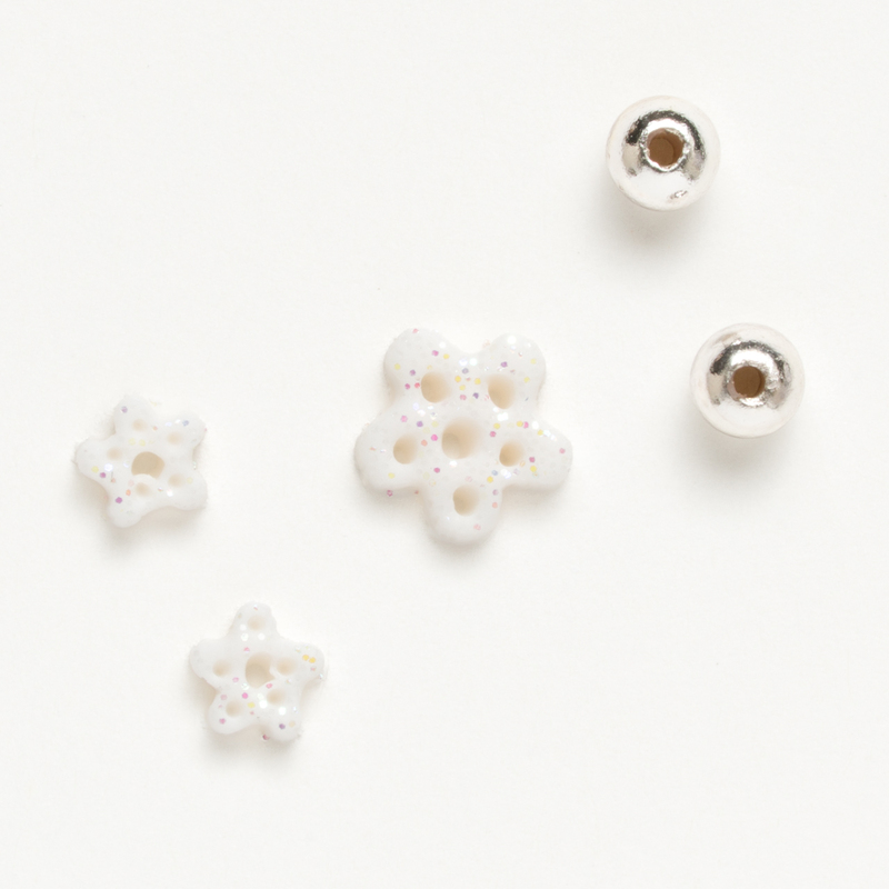 Clay button pack with winter themed charms, isolated on a white background. 