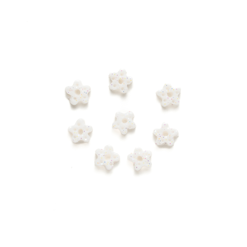 Set of 8 small white glittery clay snowflake buttons, isolated on a white background. 