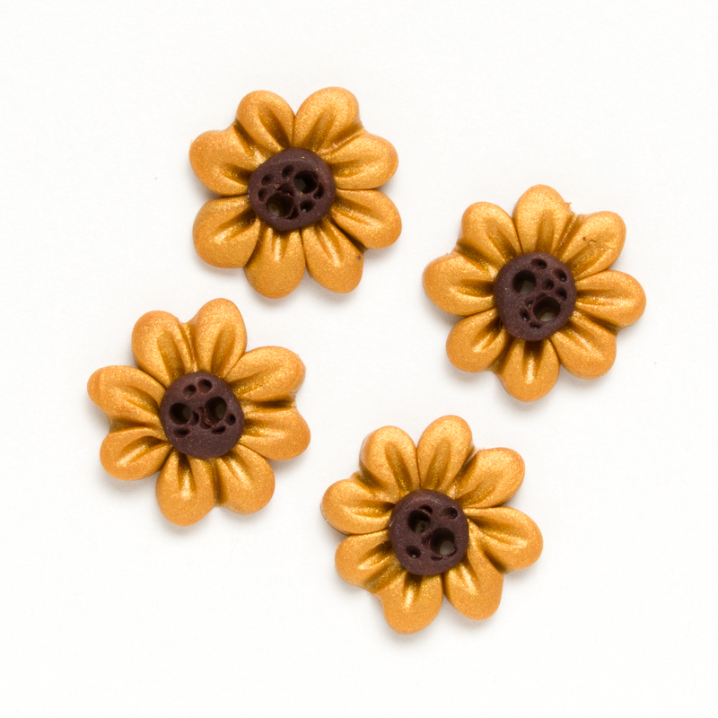 Four small yellow flower buttons with dark brown centers on a white background.