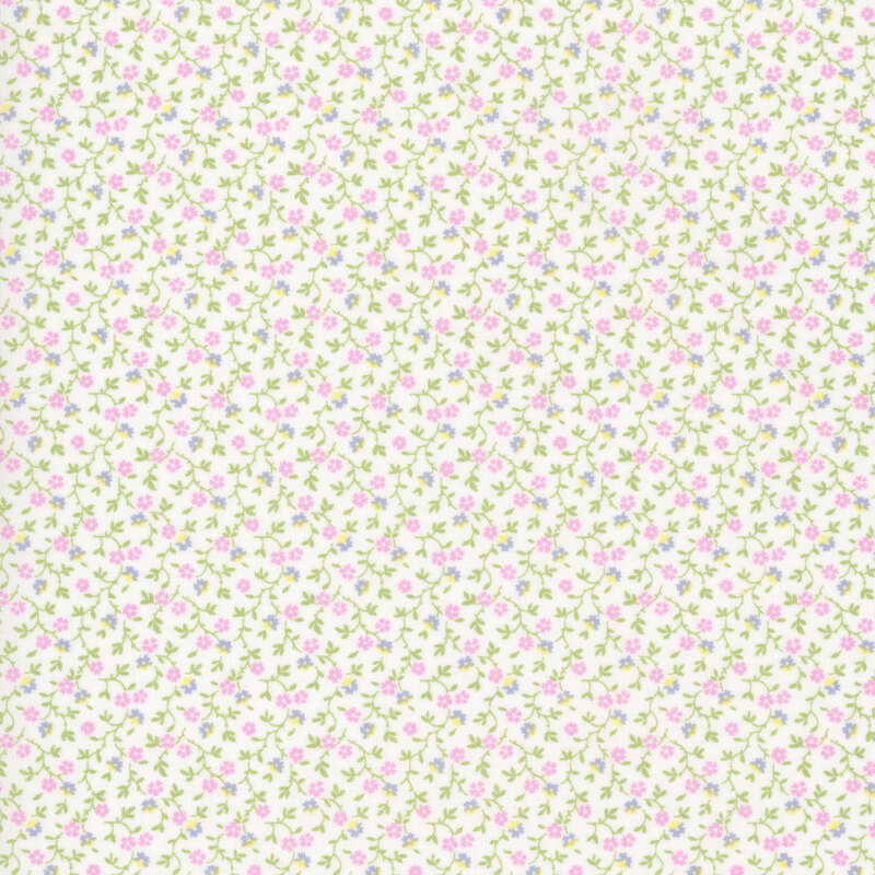 White fabric with a pattern of leafy green vines accented with pink, blue, and yellow blossoms 