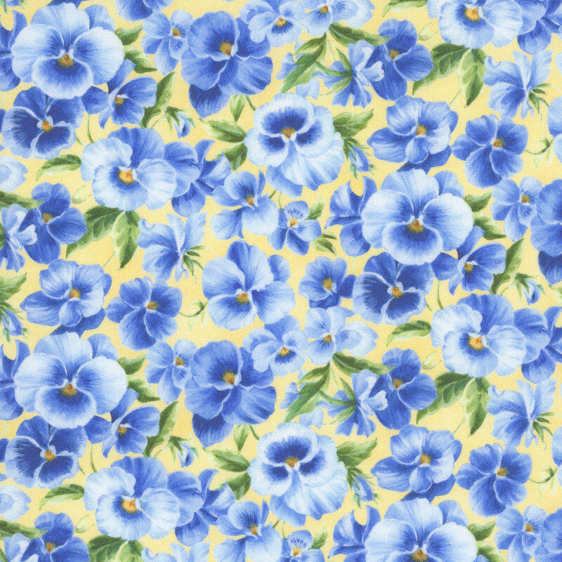 Soft yellow fabric packed with light and dark blue pansies.