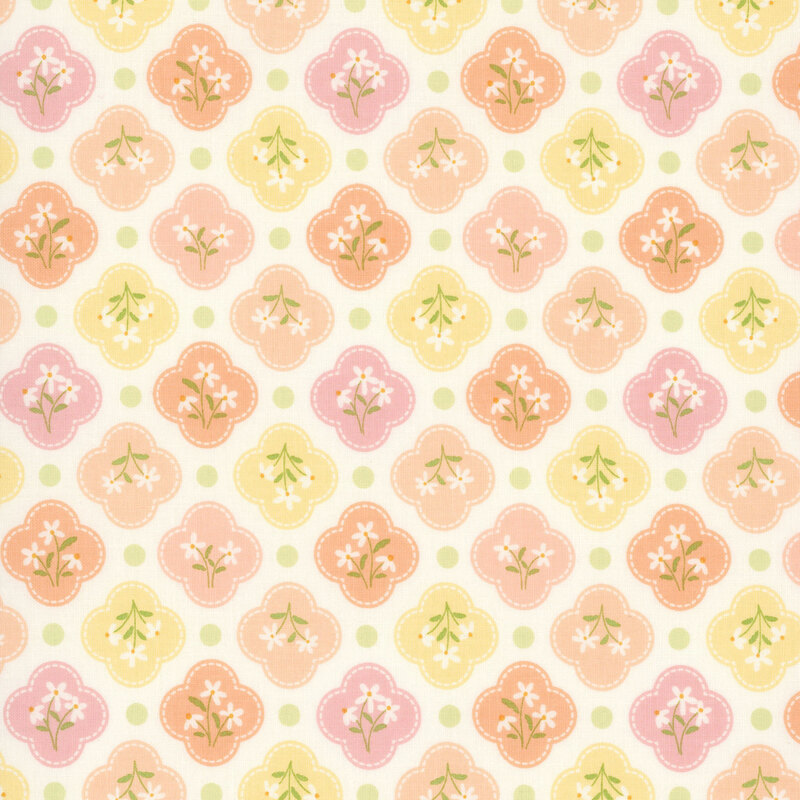This white fabric features pastel yellow, peach, and pink quatrefoils amongst spring green dots. 