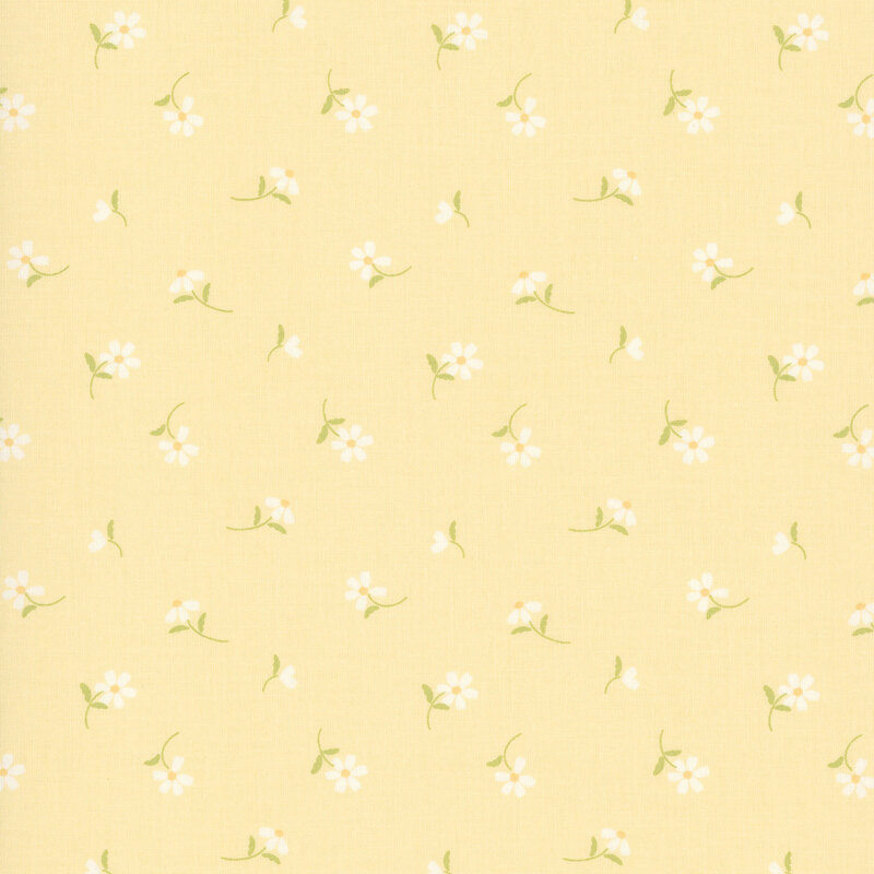This cornsilk yellow fabric features tossed white daisies. 