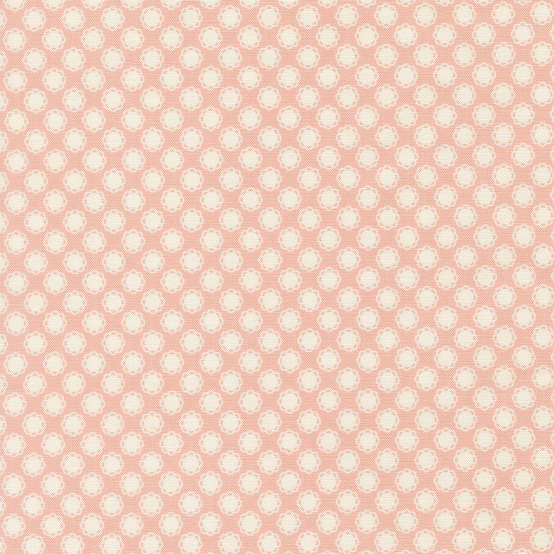 This light pink fabric features white doily motifs. 