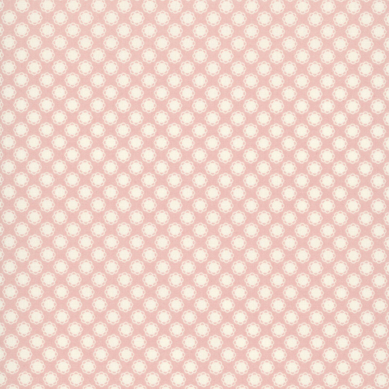 This light pink fabric features white doily motifs. 