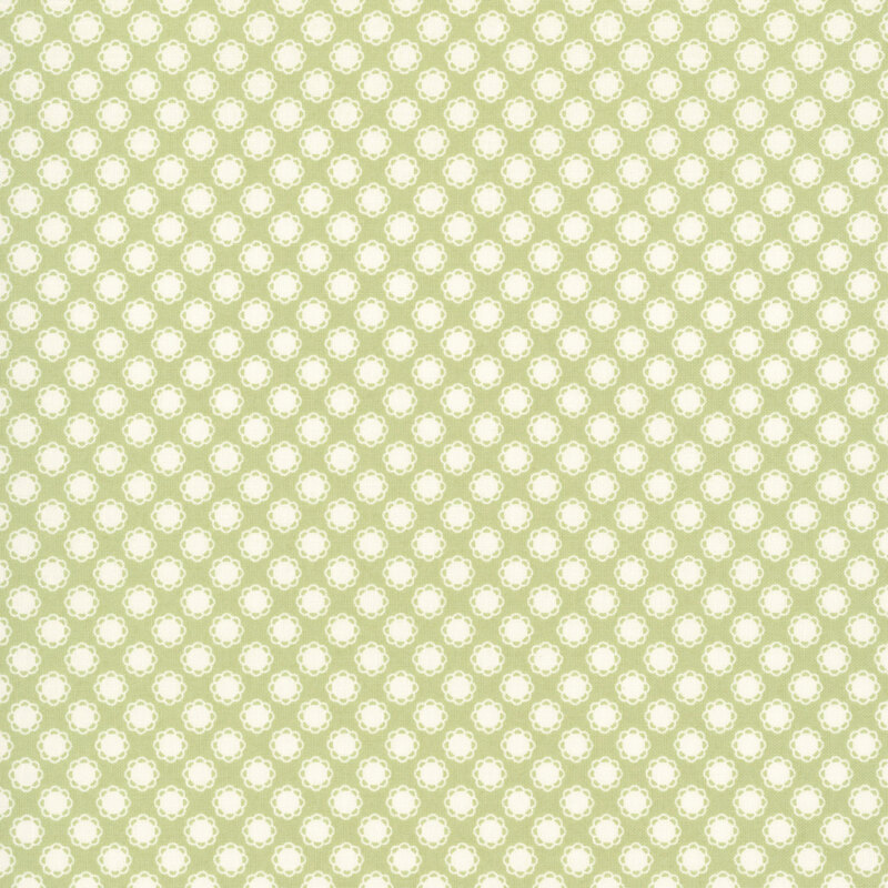 This spring green fabric features white doily motifs. 