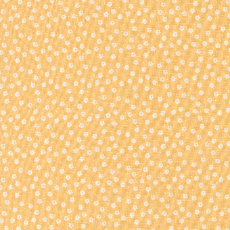 This peach ditsy fabric features white florals. 