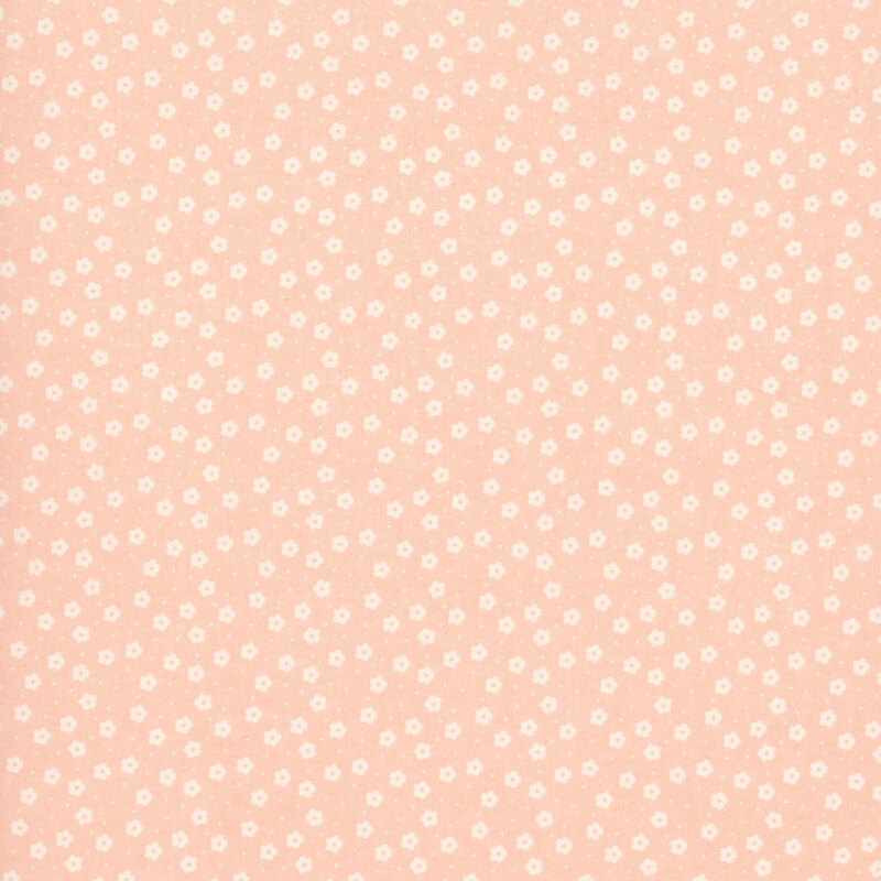 This nude pink ditsy fabric features white florals. 