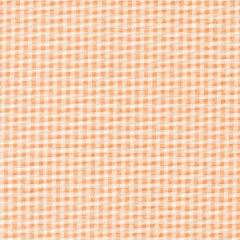 A swatch of a peach and white gingham fabric. 