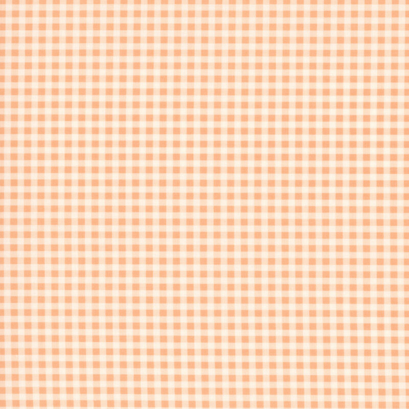 A swatch of a peach and white gingham fabric. 