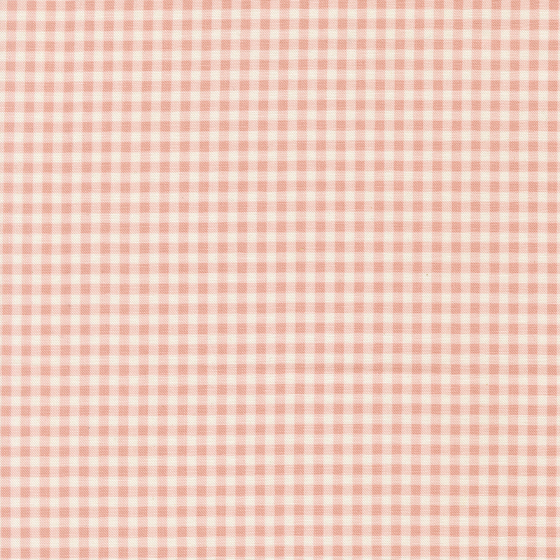 A swatch of a soft pink and white gingham fabric. 