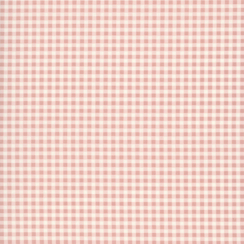 A swatch of a soft pink and white gingham fabric. 