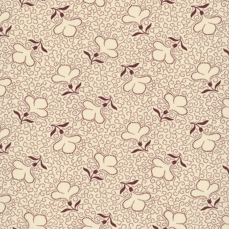 Tan fabric with a packed design of red dotted swirls and tossed dotted florals.