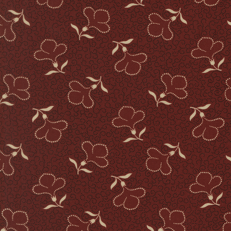 Red fabric with a packed design of dotted black swirls and cream-colored, tossed dotted florals.