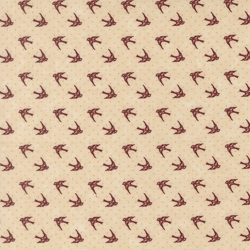 Tan fabric with dotted tonal background topped with red cardinals in flight.