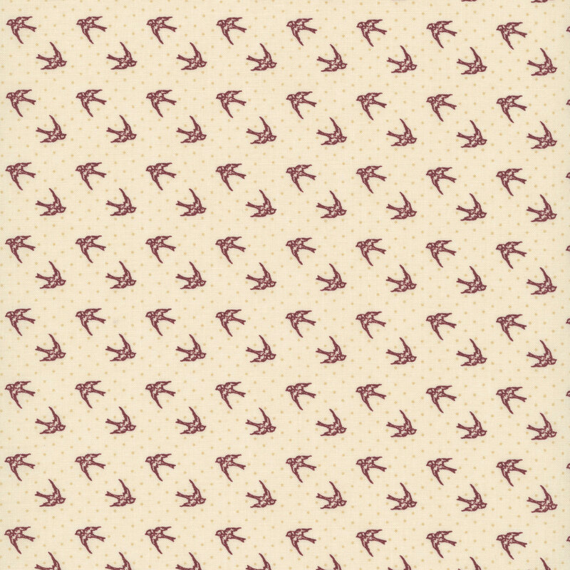 Tan fabric with dotted tonal background topped with red cardinals in flight.