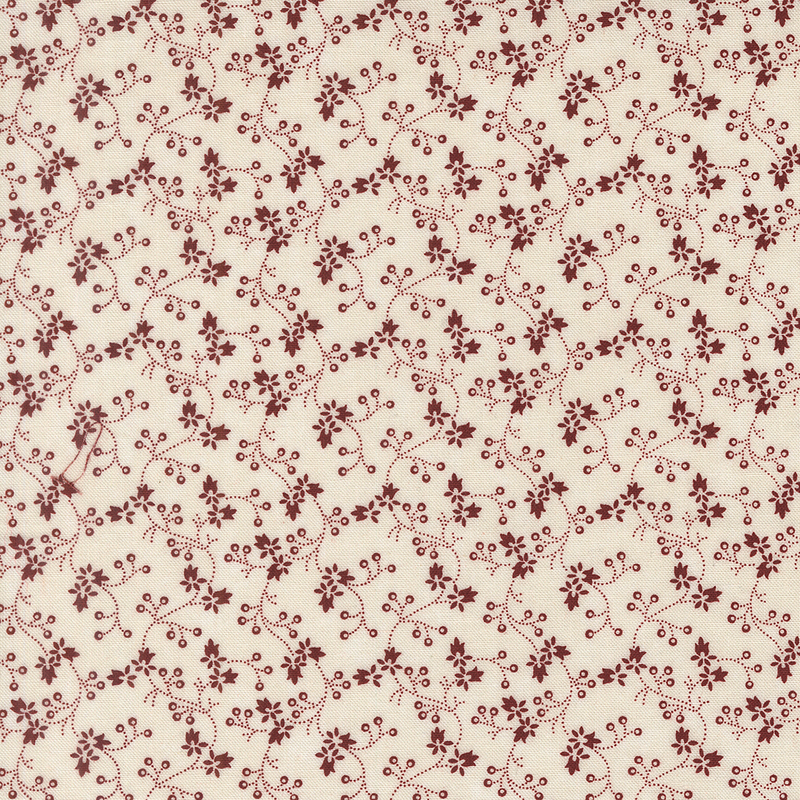 Cream fabric with a pattern of vertical red vines and florals.
