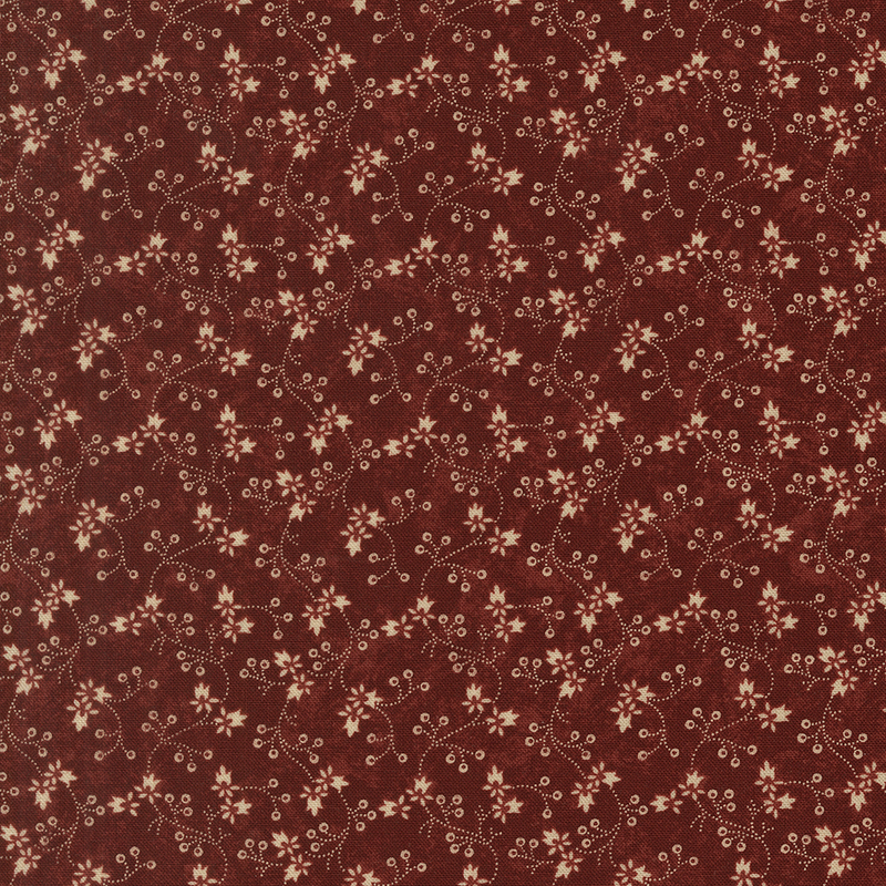 Red fabric with a pattern of vertical tan vines and florals.