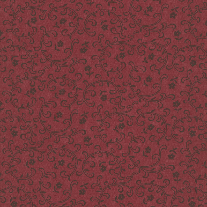 Red fabric with tossed black florals and stylized leaves and vines.