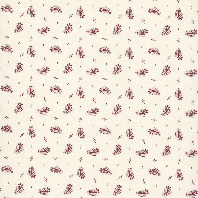 Cream fabric with a tossed design of red dots and abstract red floral motifs.