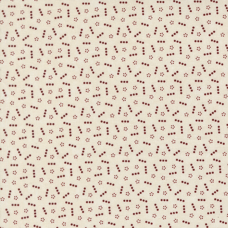 Tan fabric topped with a scattered pattern of lines and groups of small red dots.