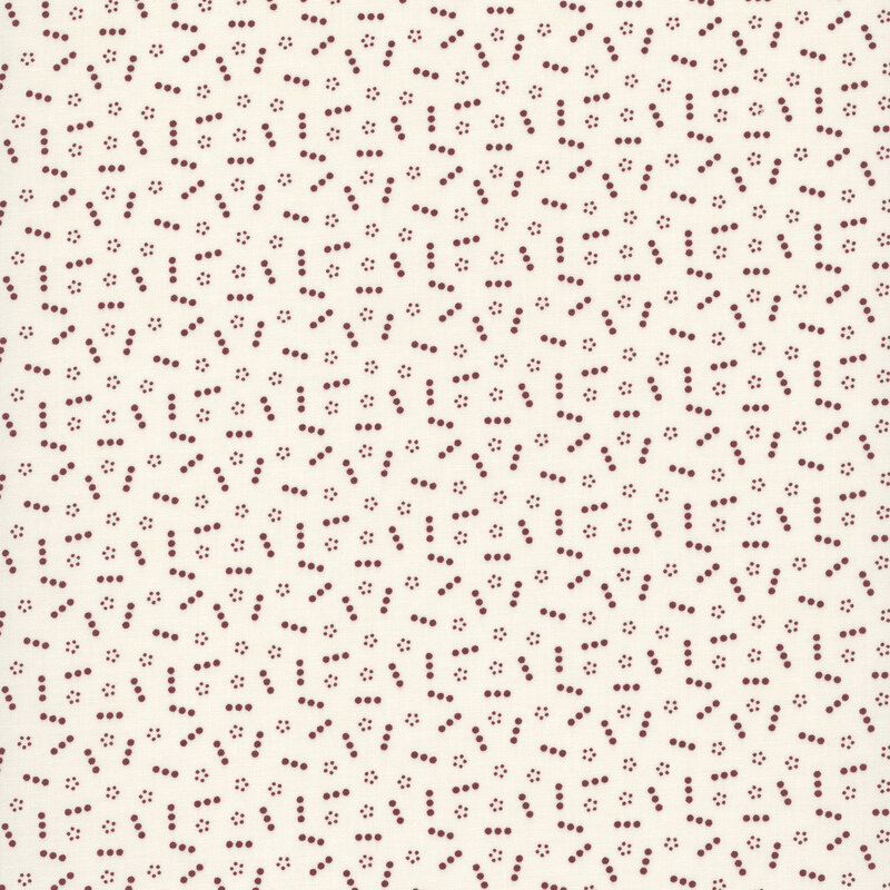 Tan fabric topped with a scattered pattern of lines and groups of small red dots.