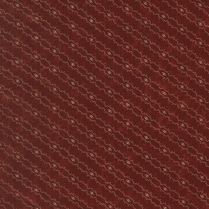 Red fabric with a biased, tan barbed wire line design.