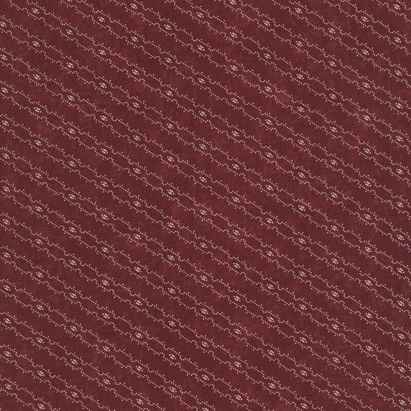 Red fabric with a biased, tan barbed wire line design.