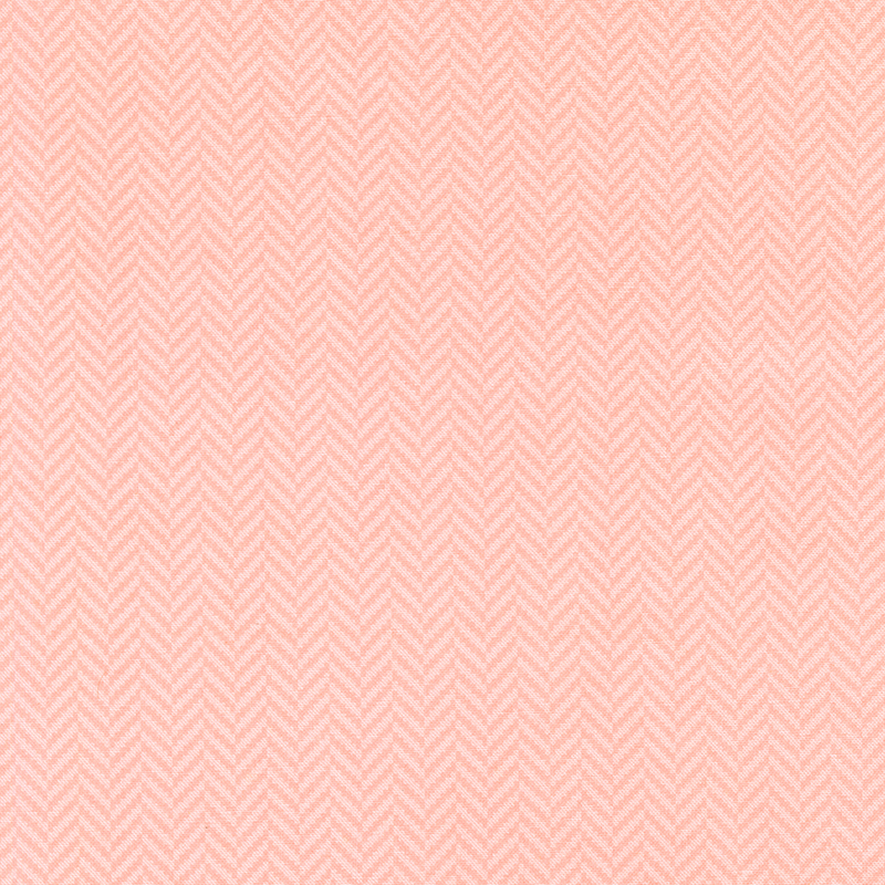 A peachy pink fabric featuring a small tonal herringbone pattern.