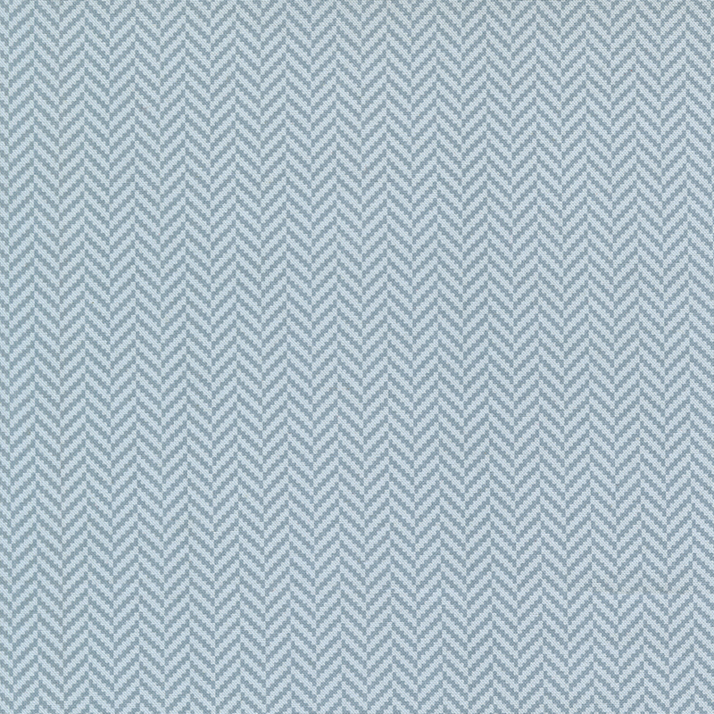 A gray blue fabric featuring a small herringbone pattern.