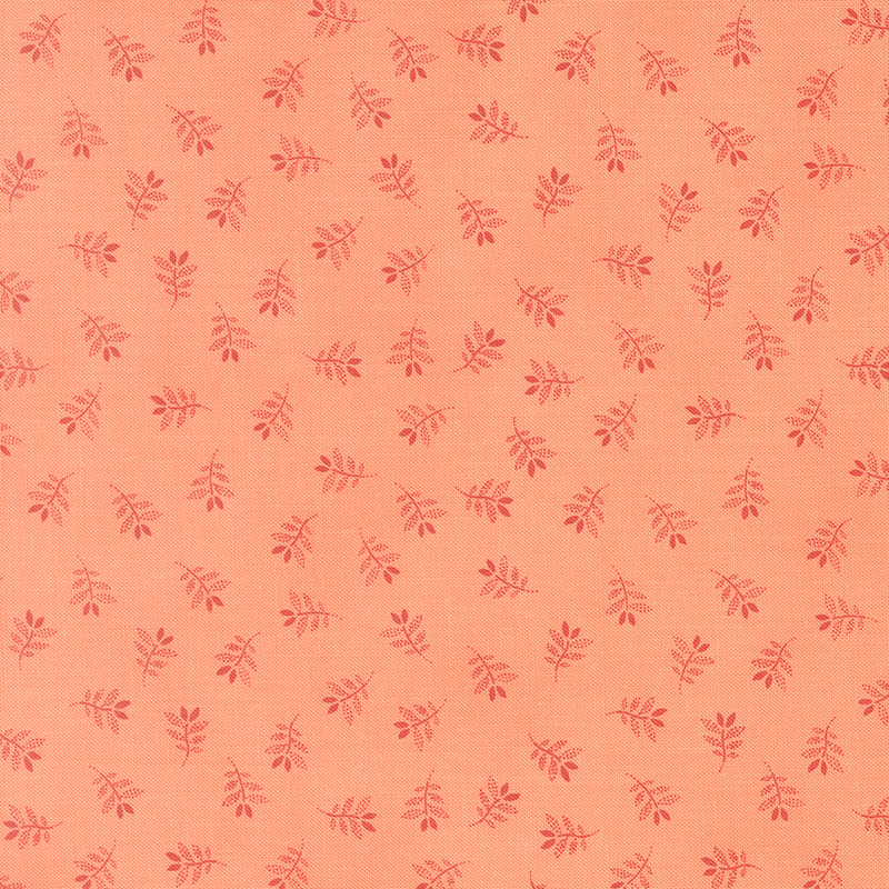 Salmon fabric with a charming tossed pattern of gracefully stylized leaves.