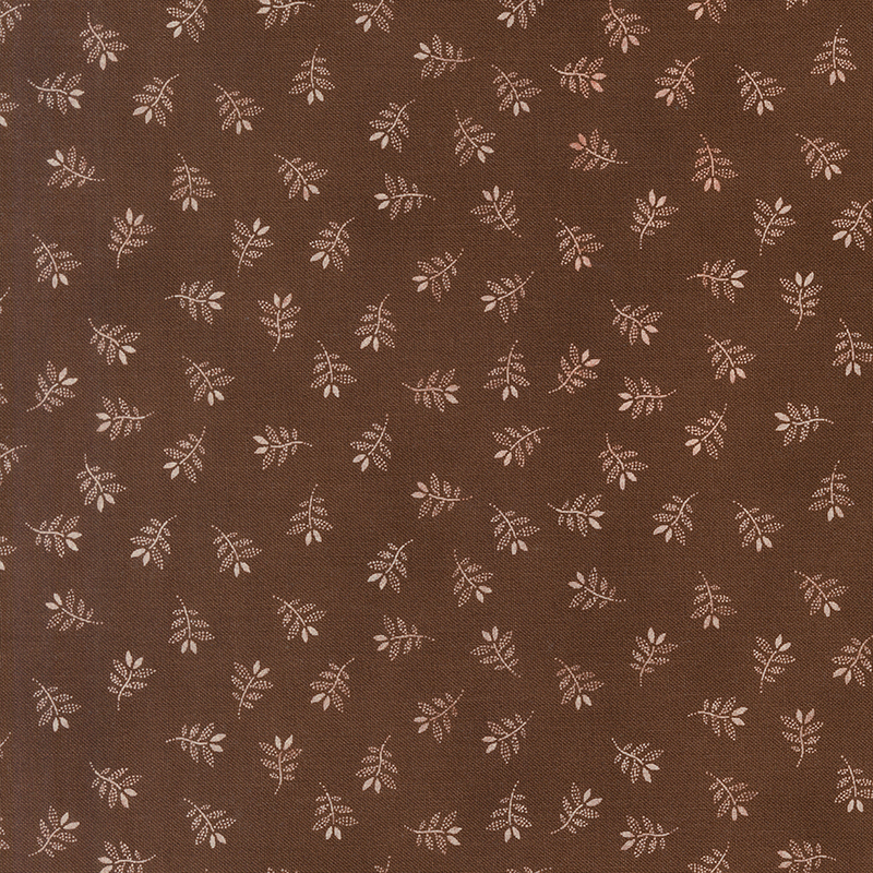 Brown fabric with a charming tossed pattern of gracefully stylized leaves.