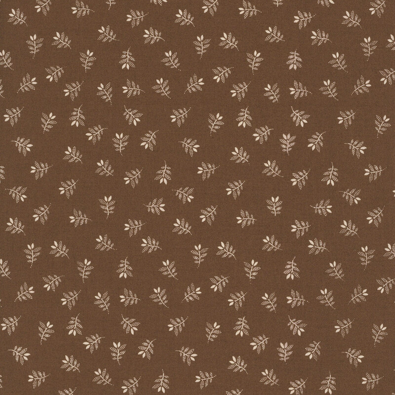 Brown fabric with a charming tossed pattern of gracefully stylized leaves.