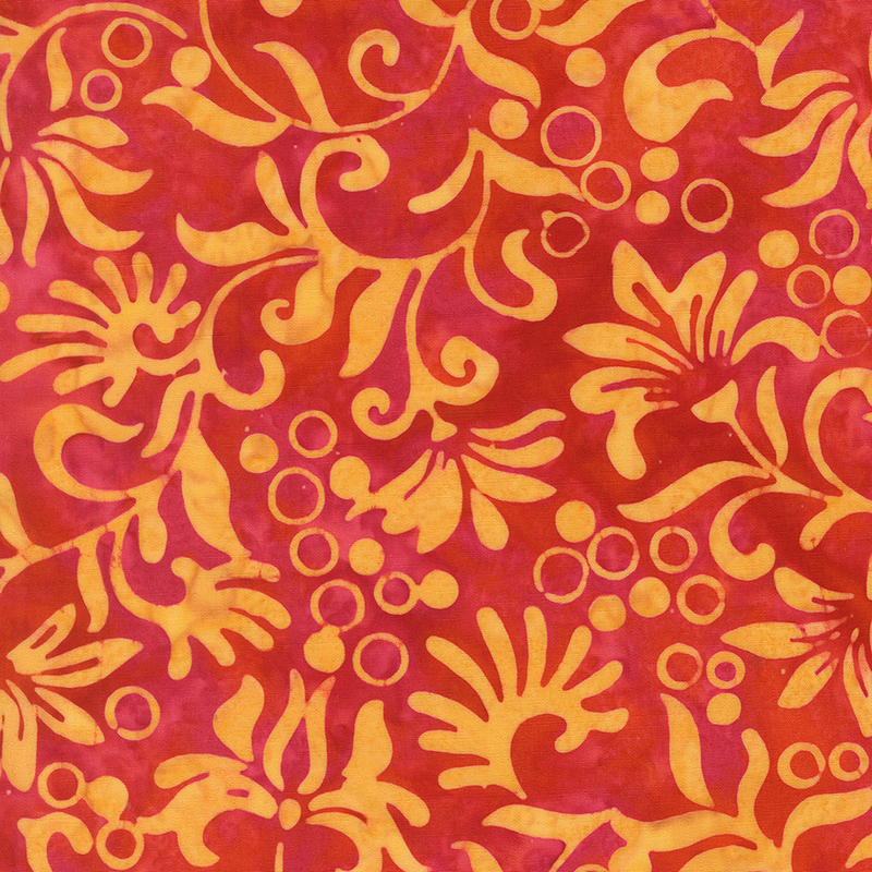 Red batik with an overlaying orange-yellow design of florals and circles.