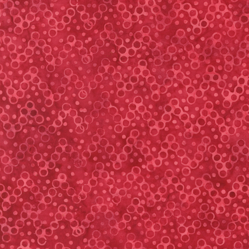 Ruby red and pink batik overlayed with a zig-zag pattern of pink circles and dots.