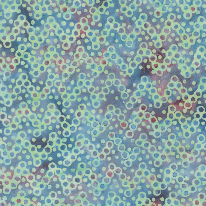 Light aqua and pink batik topped with a turquoise design of circular zigzag lines.