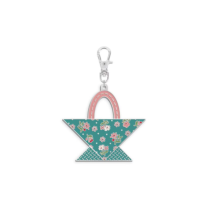 Enamel charm with a metal clip featuring the design of a teal and pink floral basket isolated on a white background.