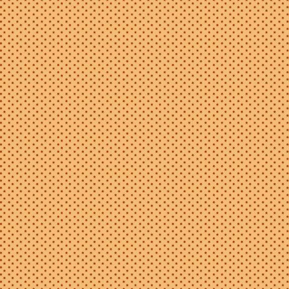 A light orange fabric with rusty red polka dots. 