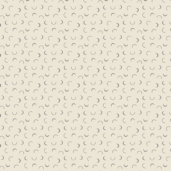 A cream fabric with gray crescent moons and dotted half-circles. 