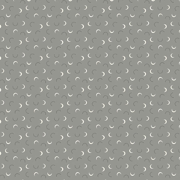 A gray fabric with white crescent moons and black dotted half circles. 