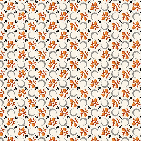 A white fabric with scattered crescent moons, floral sprigs, and leaves. 