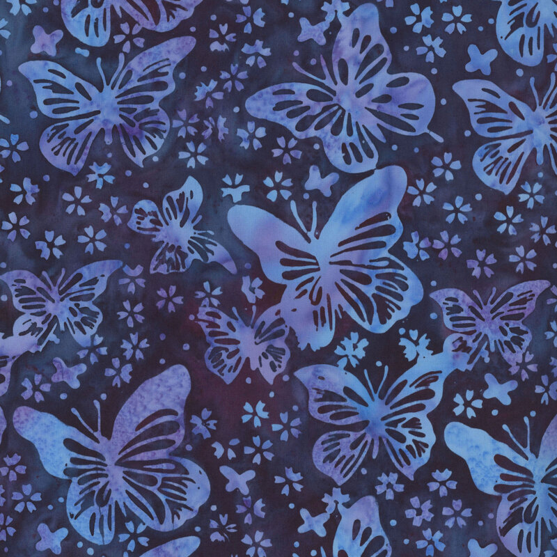 mottled midnight purple batik fabric featuring butterflies with stylized floral blossoms and dots in shades of light blue and lilac lavender